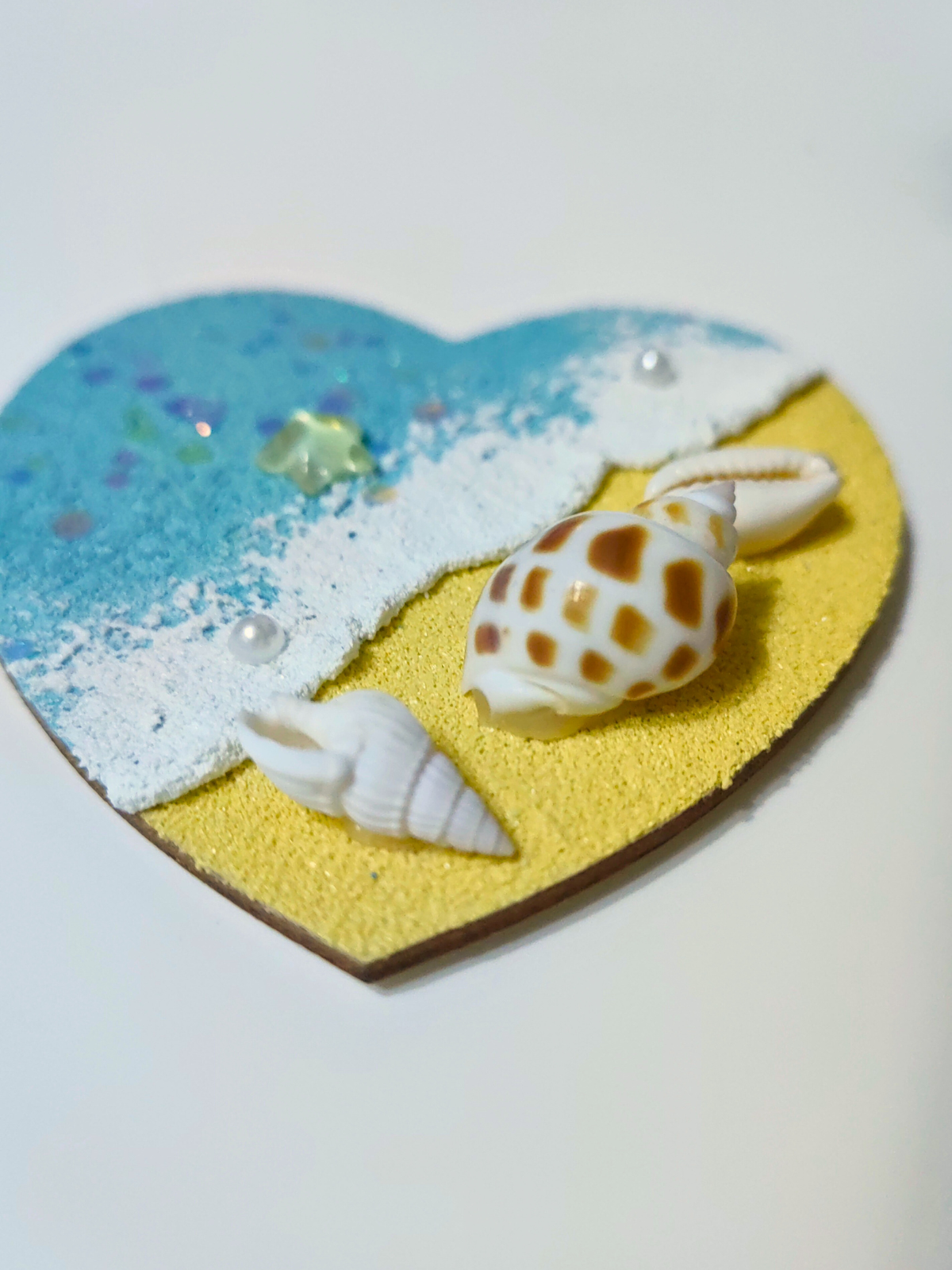Close-up shell detail on heart-shaped wood magnet