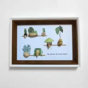 Framed coastal art with lighthouse and shells