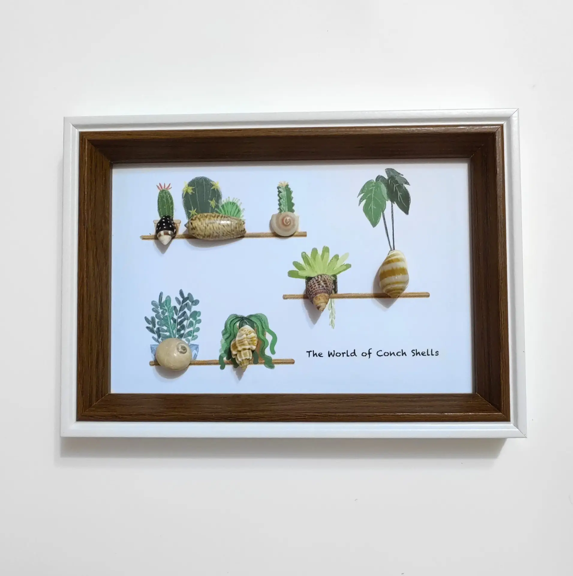 Framed coastal art with lighthouse and shells
