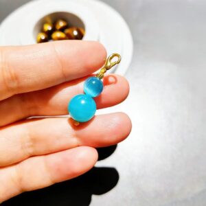 Handmade double bead charm with blue-green translucent beads