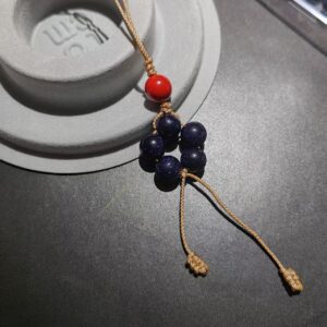 Hand-woven starry obsidian five-star charm with cinnabar bead and sand-gold cord by PICKLNN