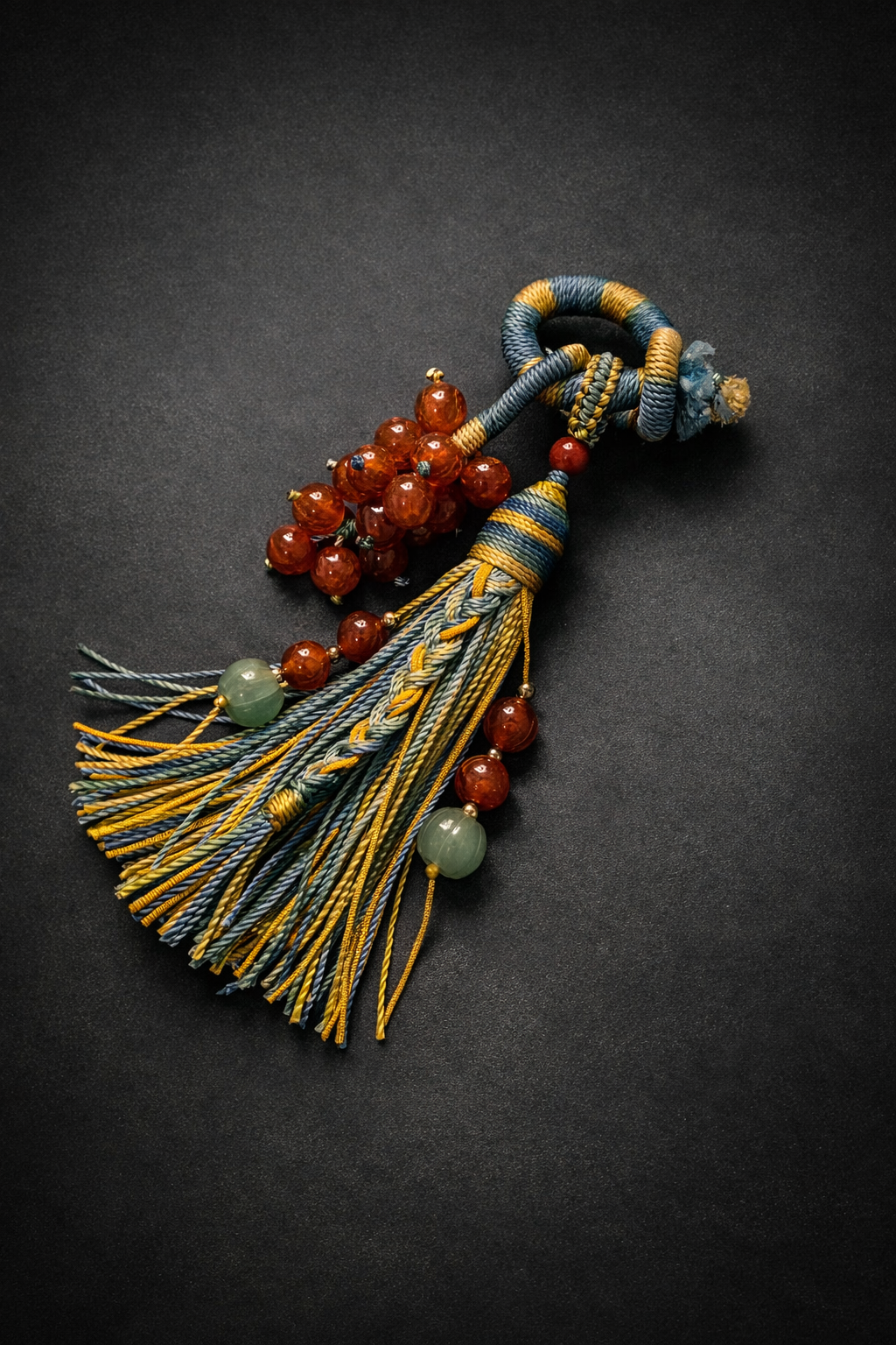 handmade knotted tassel pendant with natural 8mm bead grape cluster on dark background