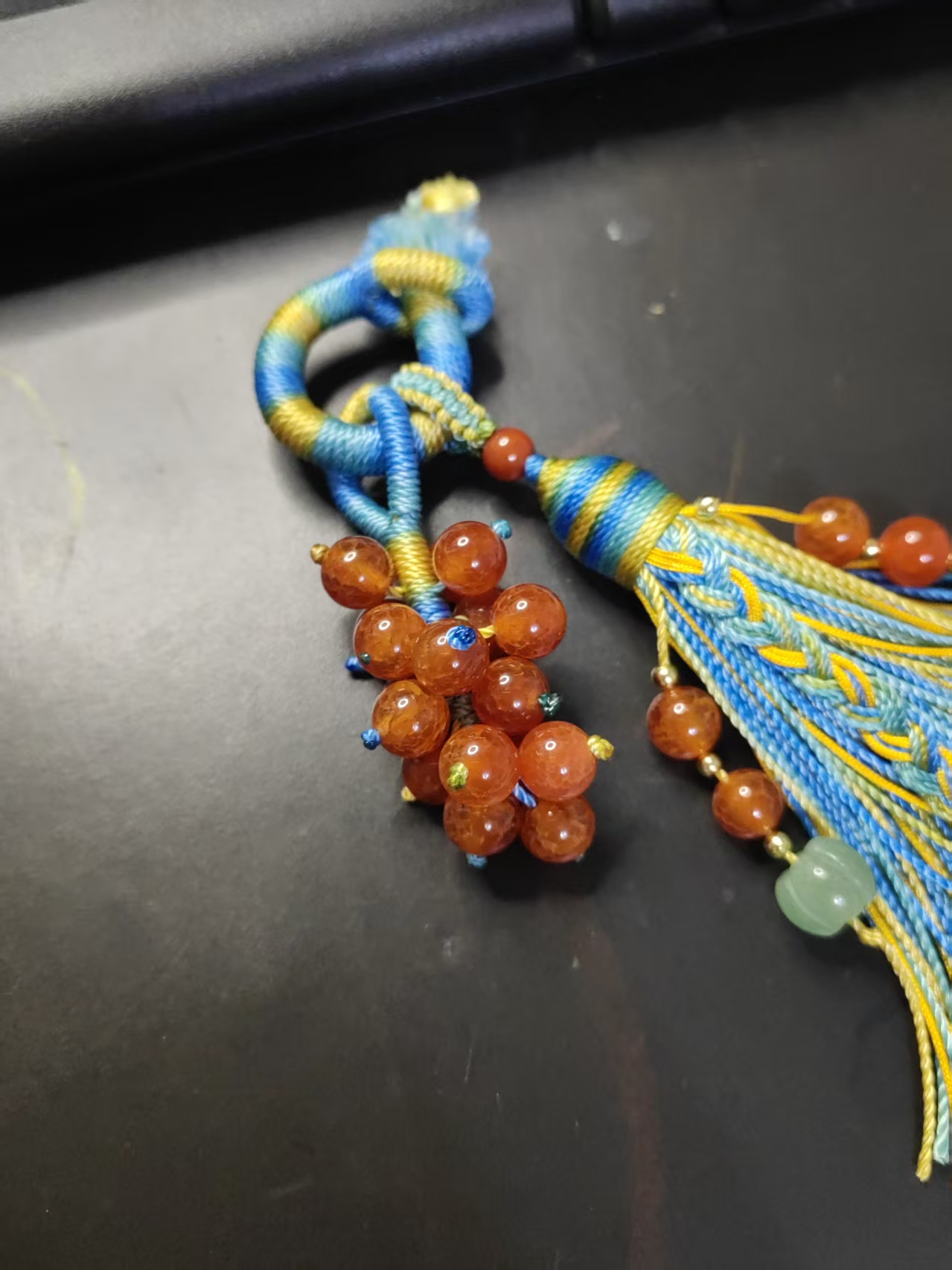 handwoven pendant detail showing grape cluster made of 20 natural 8mm beads