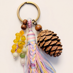 Hand-knotted Slik Tassel Charm with Pine Cone Accent - bohemian style keychain accessory.