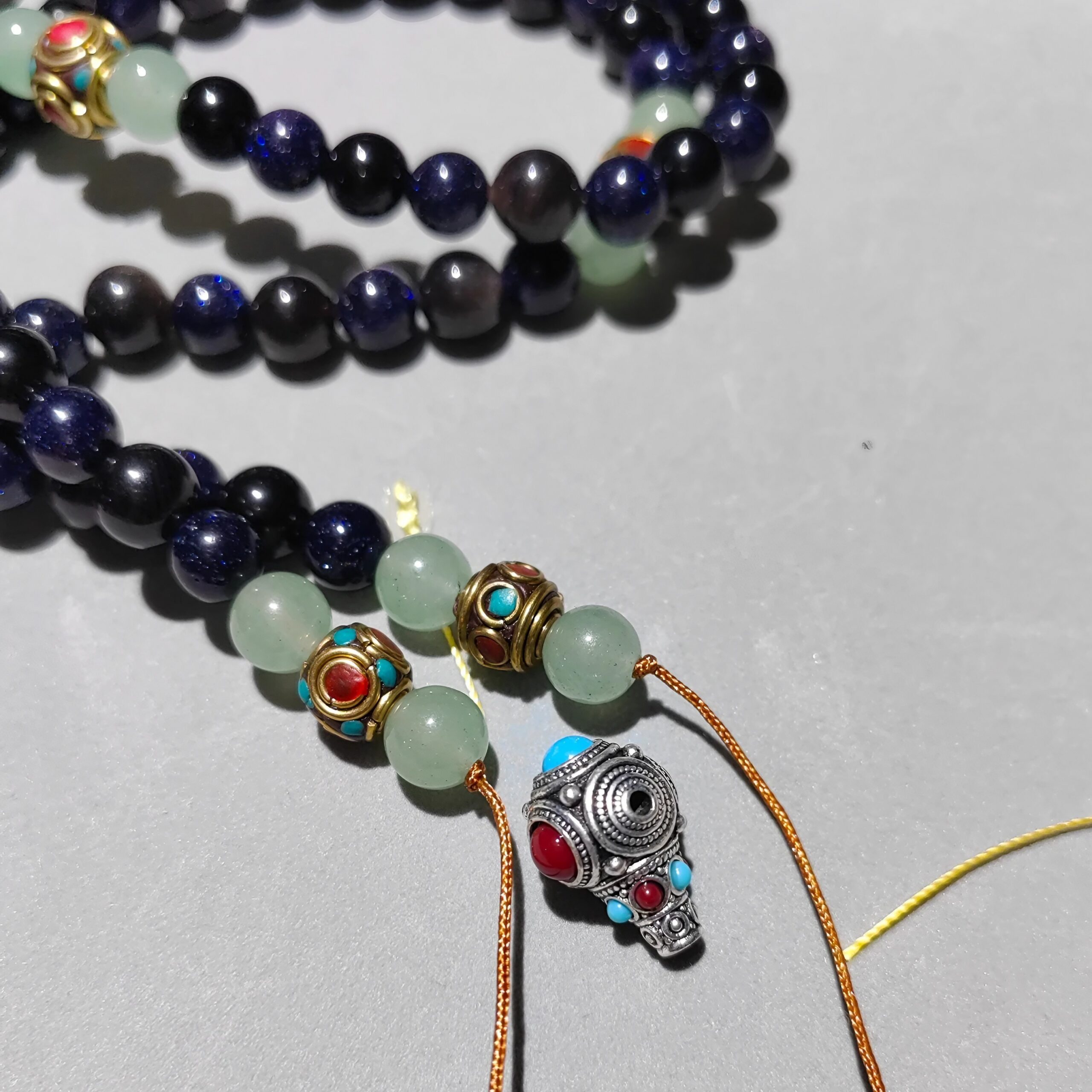 Detail shot of 0.8mm natural Obsidian beads and Size 72 high-tenacity Jade cord.